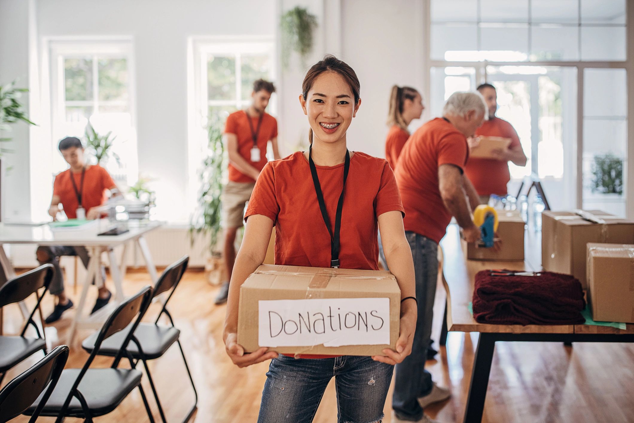 Volunteer holding a donation box for community support